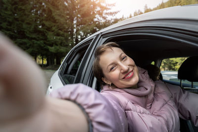 Portrait of happy woman in car