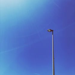 Low angle view of street light against clear blue sky