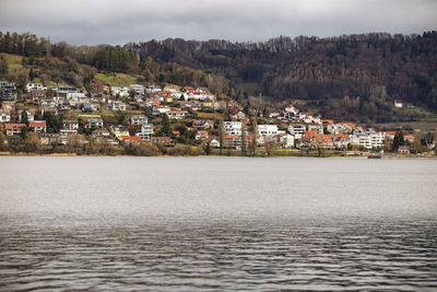 Townscape by sea against sky