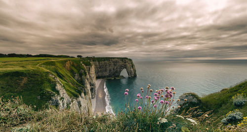 Scenic view of sea against cloudy sky