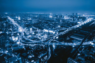 High angle view of illuminated buildings in city at night