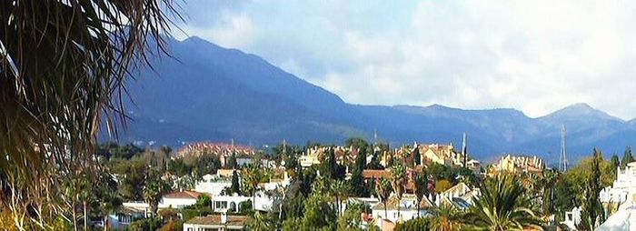 Scenic view of mountains against cloudy sky