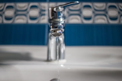 Close-up of water faucet on table