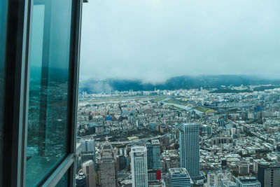 High angle view of city buildings against sky