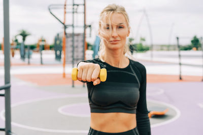 Portrait of woman exercising in gym