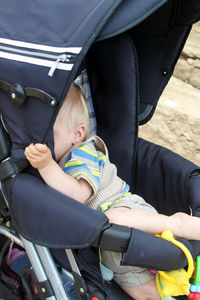 High angle view of baby boy sleeping in stroller