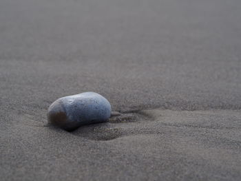 Close-up of stones on sand