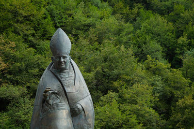 Statue of buddha against trees
