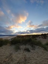 Scenic view of beach against sky during sunset