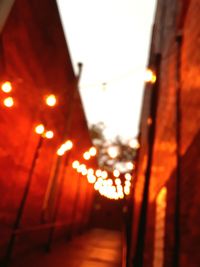 Defocused image of illuminated street lights in city at night