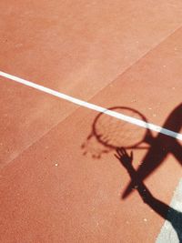 High angle view of shadow of man on floor