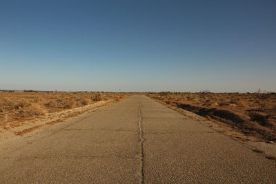 Road amidst landscape against clear sky