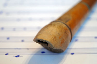 Close-up of flute on sheet music