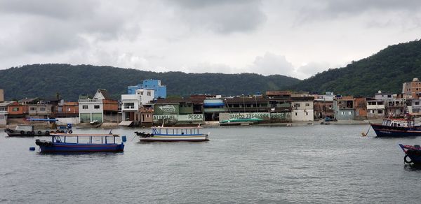 Scenic view of sea by buildings against sky