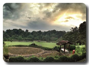 Scenic view of field against cloudy sky