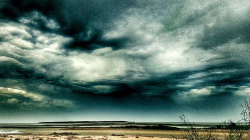 Scenic view of sea against cloudy sky