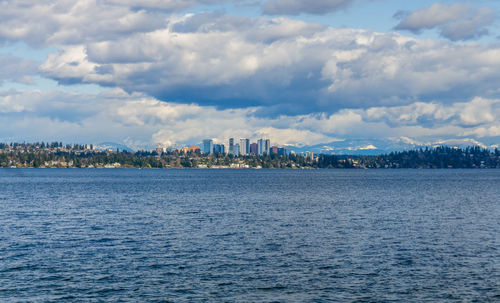 Modern buildings in bellevue, washington with the cascades range in the background.