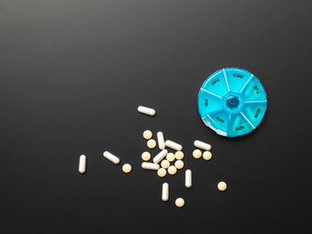 High angle view of glasses on table against black background