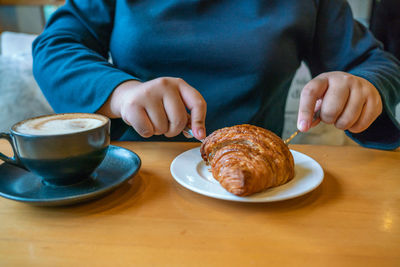 Midsection of man having breakfast