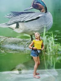 Full length of smiling girl standing in lake