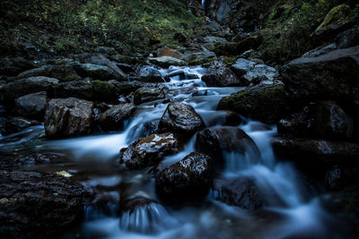 Stream flowing through rocks in forest