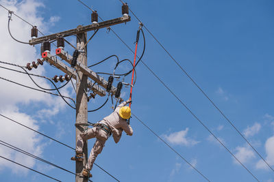 Low angle view of cables against blue sky