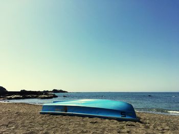 Scenic view of beach against clear blue sky