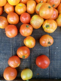 Directly above shot of tomatoes on wooden table at market for sale
