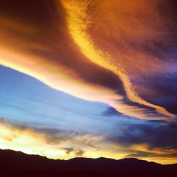 Scenic view of mountains against dramatic sky