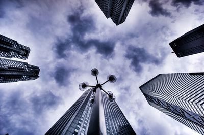 Low angle view of modern building against cloudy sky