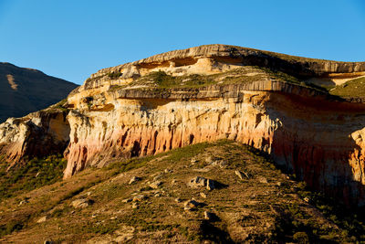 Rock formations on mountain against sky