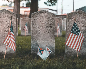 Flags on grass in cemetery