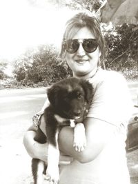 Portrait of cute puppy sitting outdoors