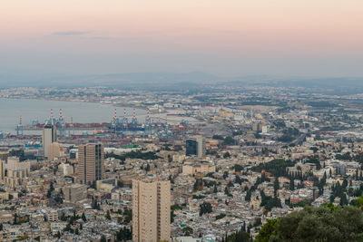 High angle view of buildings in city against sky during sunset