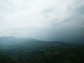 Scenic view of mountains against cloudy sky