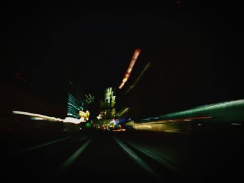 Light trails on road in city at night
