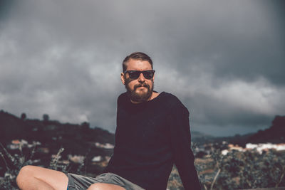Portrait of man wearing sunglasses against sky