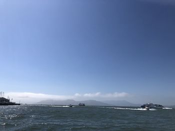 Scenic view of sea against clear blue sky