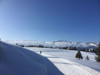 Scenic view of snowcapped mountains against cloudy sky