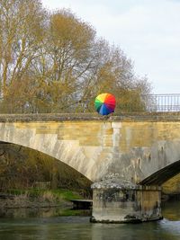 Arch bridge over river against sky