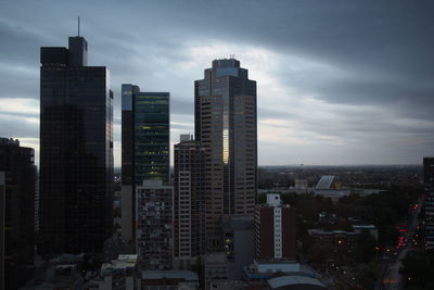 View of cityscape against cloudy sky