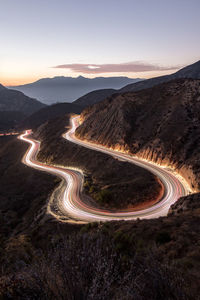 Trail lights on mountain road at dusk