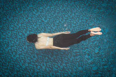 High angle view of woman swimming in pool