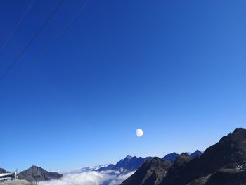 Scenic view of snowcapped mountains against clear blue sky