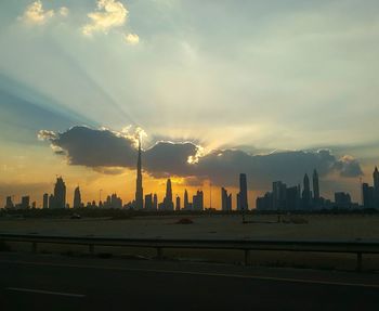 Scenic view of city against sky during sunset