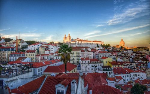 High angle view of buildings against blue sky