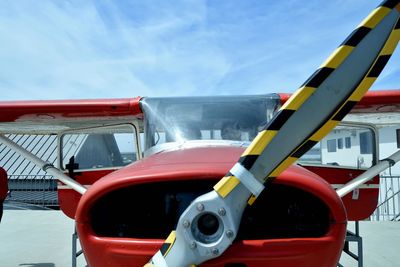 Close-up of red airplane against sky