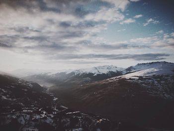 Scenic view of mountains against cloudy sky