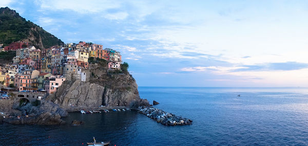 Panoramic view of sea and buildings against sky