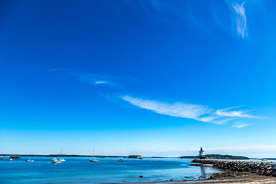 Scenic view of sea against blue sky